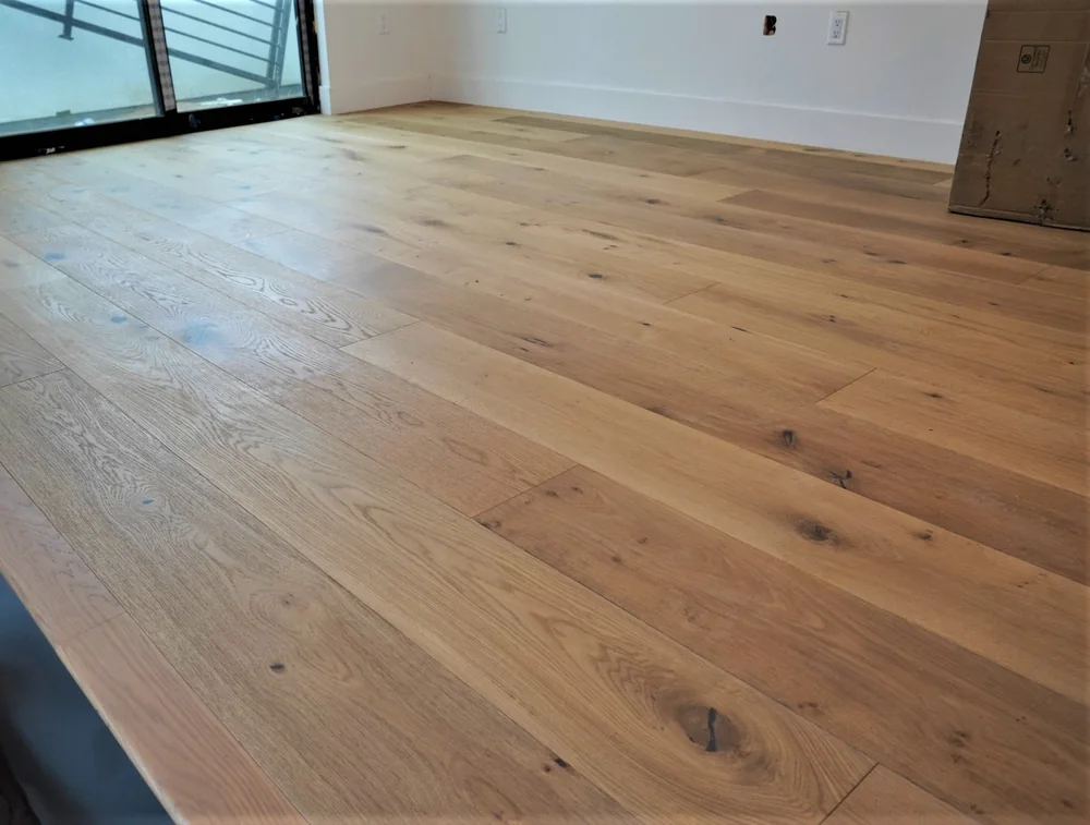 Close view of 9.5-inch European white oak engineered hardwood planks showing grain and character knots in a Los Angeles home