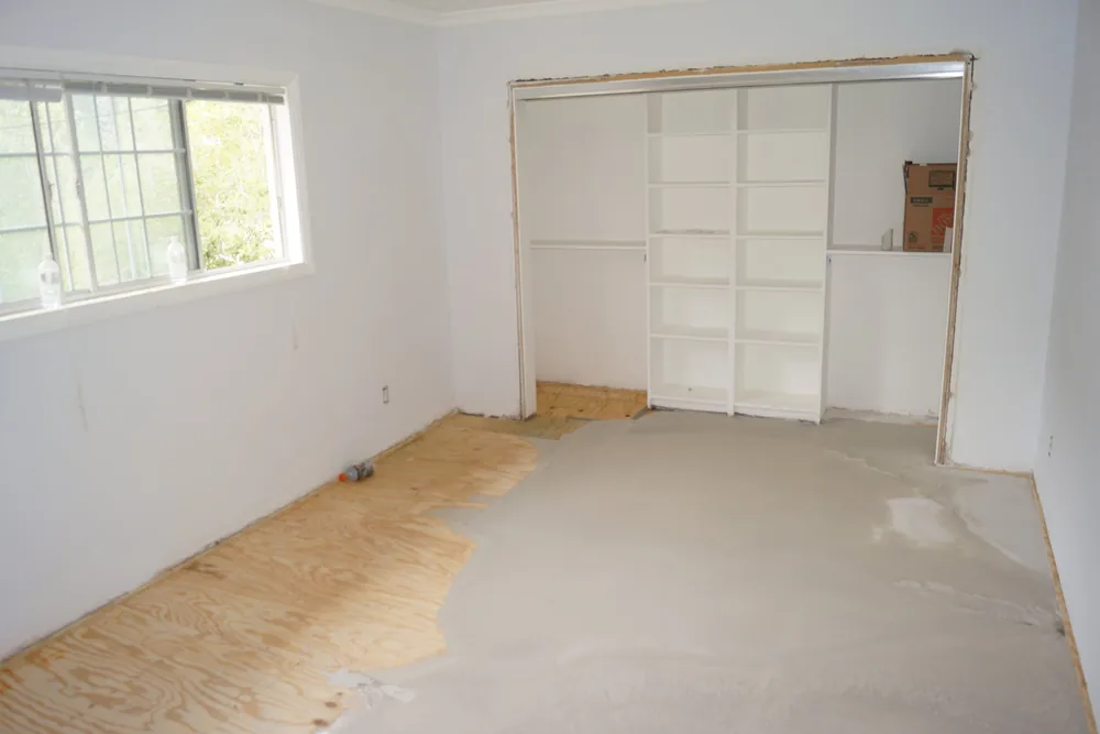 Bedroom in a Pasadena home with plywood subfloor and floor-leveling compound applied to low areas