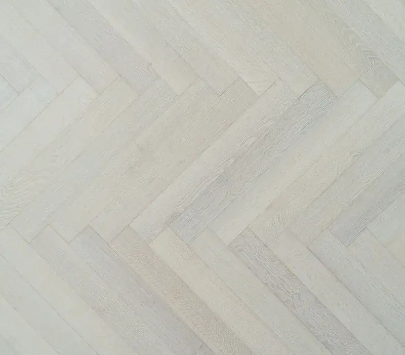 Bergamo Floors Herringbone & Chevron Oak Tramonto Herringbone European White Oak Engineered Hardwood, installed in a room
