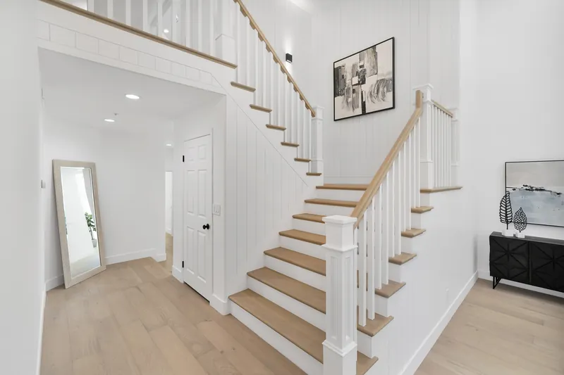 Solid white oak stair treads stained to match the hardwood floors