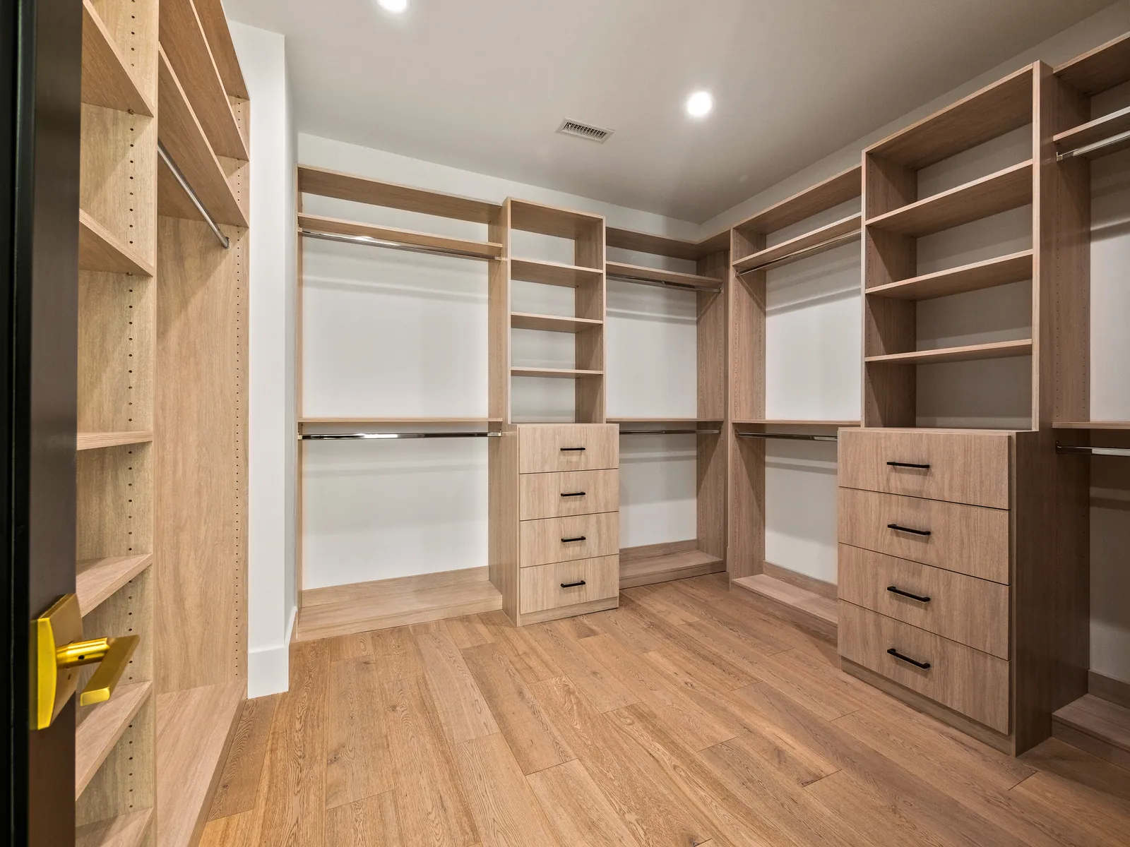 Walk-in closet with custom shelving and European oak hardwood floors
