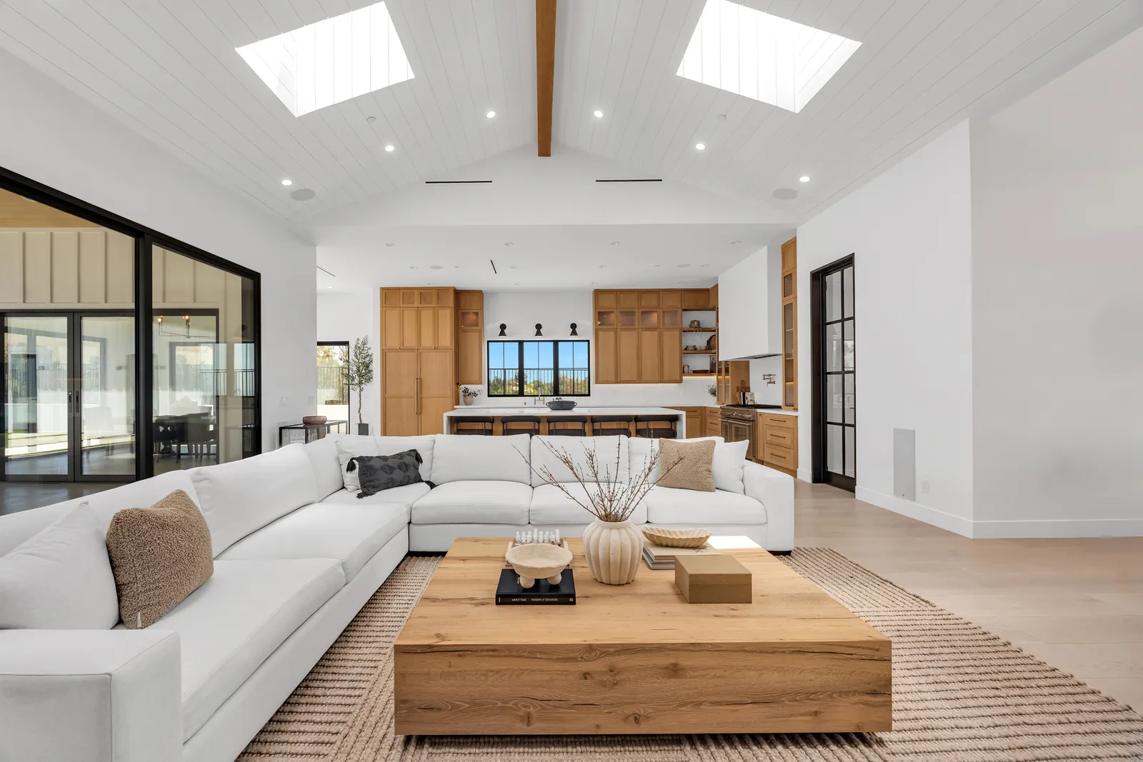 Family room and kitchen with skylights and long wide-plank oak hardwood floors