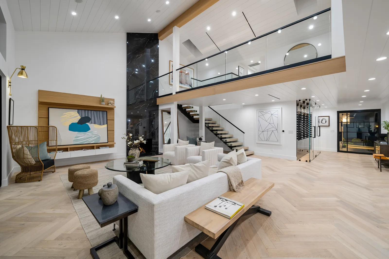 Living room with herringbone engineered oak floor and floating oak staircase