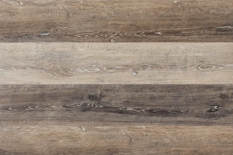 Waterproof rigid-core vinyl planks in a weathered brown oak look