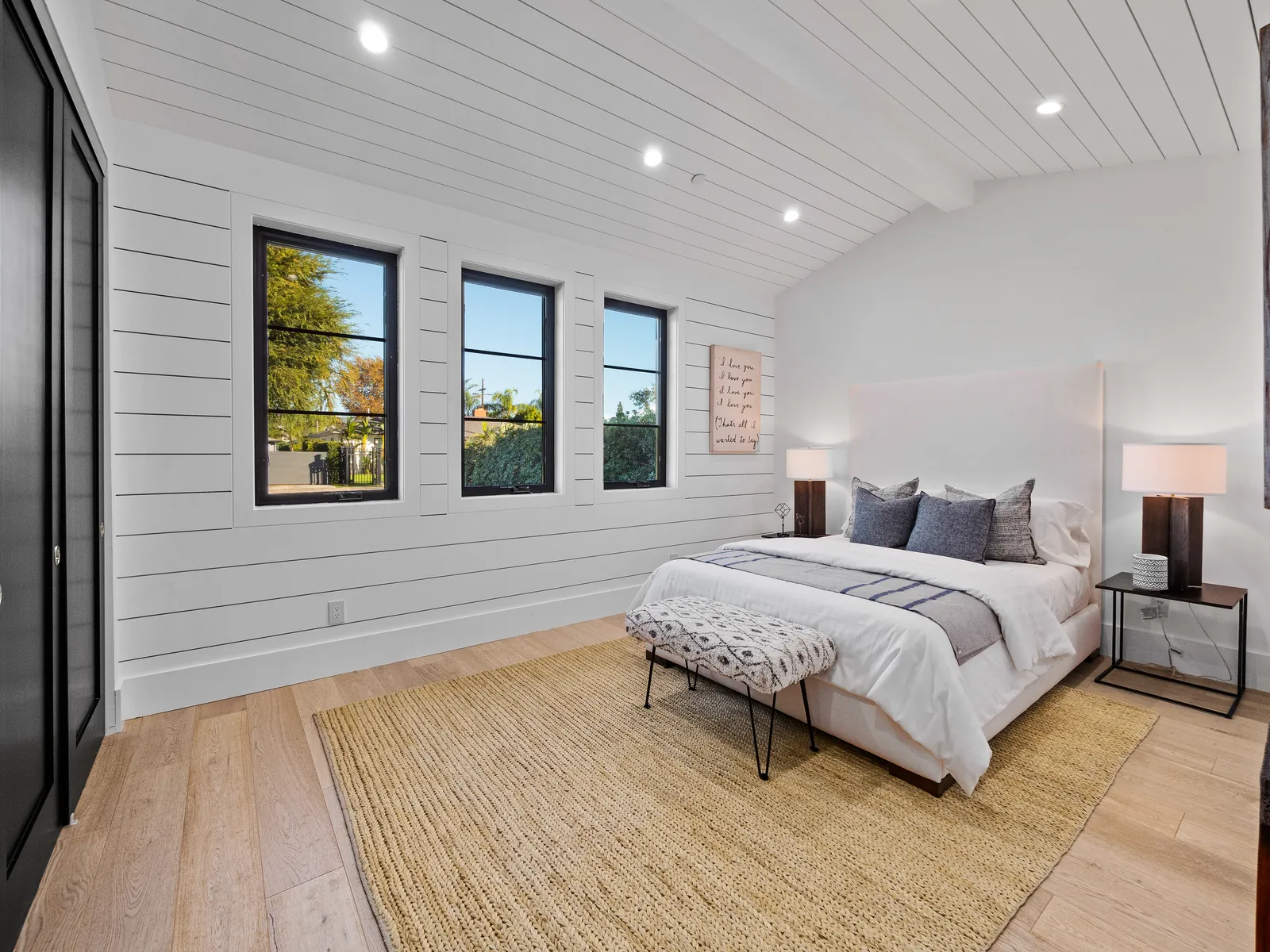 Bedroom with vaulted shiplap ceiling and wide-plank white oak hardwood floors